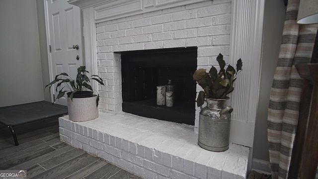 interior details with a fireplace and wood finished floors