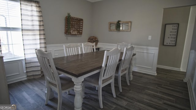 dining area featuring a wainscoted wall, plenty of natural light, dark wood finished floors, and a decorative wall