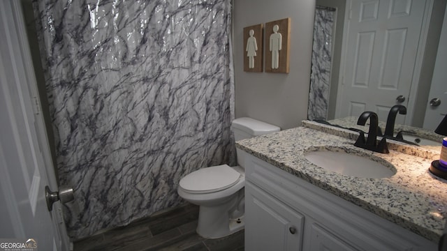 bathroom with wood tiled floor, curtained shower, vanity, and toilet