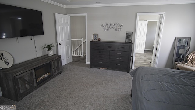 bedroom with baseboards, crown molding, and carpet flooring