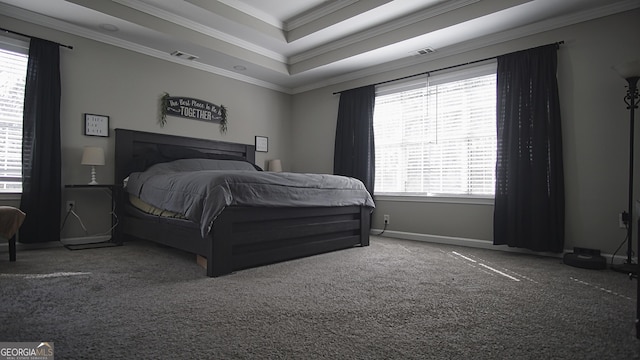 carpeted bedroom featuring ornamental molding, a raised ceiling, visible vents, and baseboards