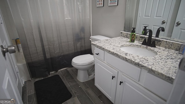 full bath featuring wood finish floors, vanity, toilet, and shower / bath combo with shower curtain