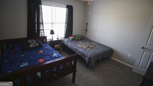 bedroom featuring carpet floors and baseboards