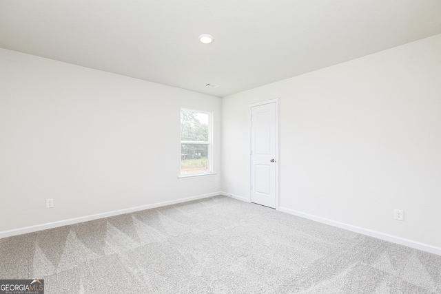 unfurnished room with carpet floors and baseboards