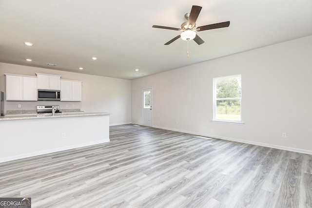 kitchen featuring a healthy amount of sunlight, stainless steel appliances, and open floor plan