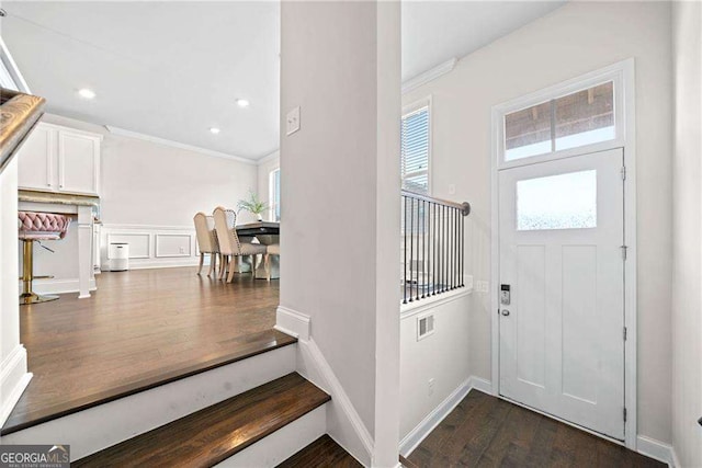 entryway featuring baseboards, ornamental molding, dark wood-type flooring, and recessed lighting