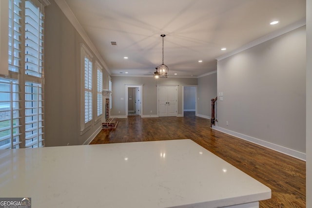 entryway with dark wood-style floors, baseboards, ornamental molding, and recessed lighting