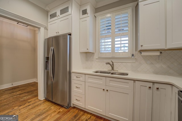 kitchen featuring light countertops, a sink, visible vents, and stainless steel fridge with ice dispenser