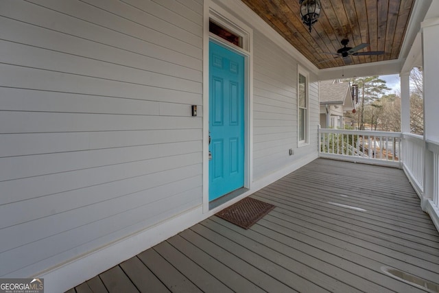 doorway to property with ceiling fan and a porch