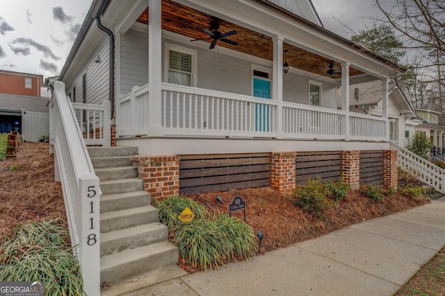 view of side of property featuring a ceiling fan, covered porch, and stairs