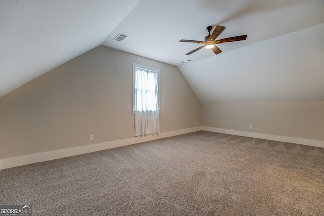 bonus room featuring lofted ceiling, carpet flooring, visible vents, and baseboards