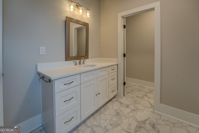 bathroom featuring marble finish floor, baseboards, and vanity