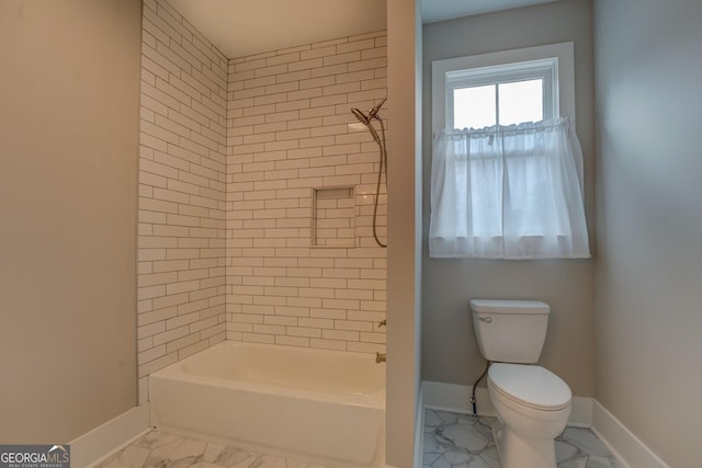 bathroom with marble finish floor, shower / bathing tub combination, toilet, and baseboards