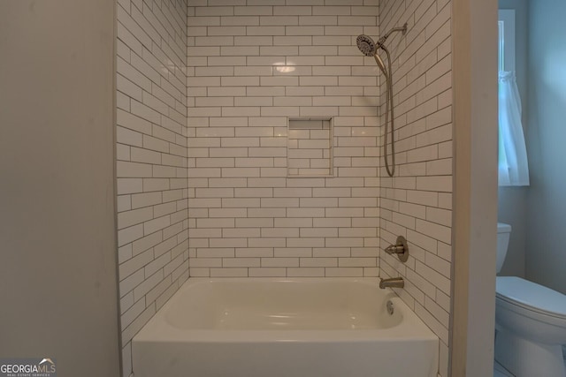 bathroom featuring shower / tub combination and toilet