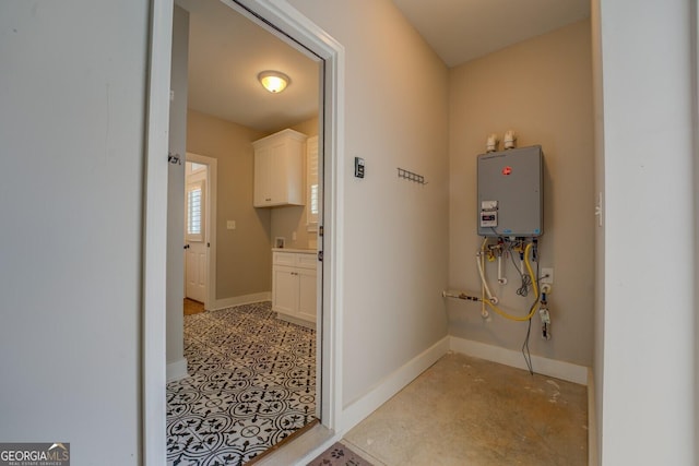 interior space featuring baseboards and tankless water heater