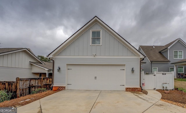 view of front of property featuring a garage, fence, and board and batten siding