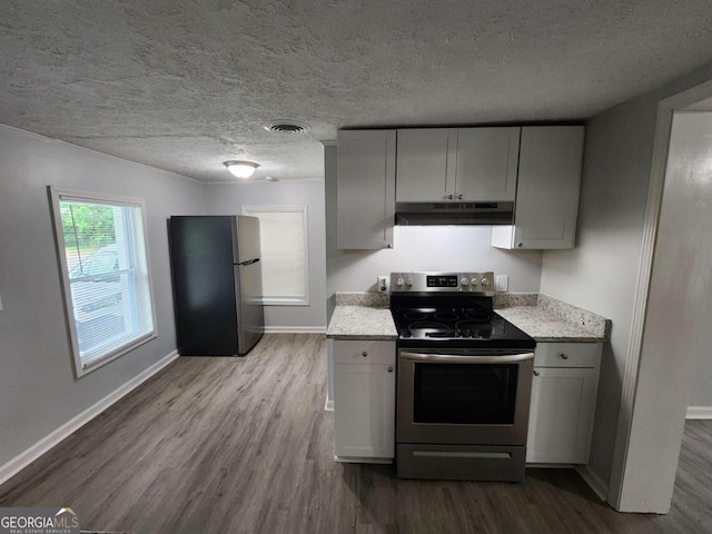 kitchen featuring appliances with stainless steel finishes, dark wood-style flooring, and under cabinet range hood