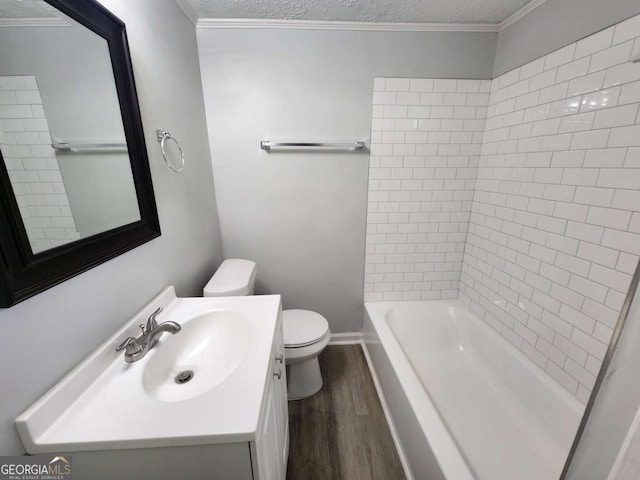 full bathroom with a textured ceiling, toilet, wood finished floors, vanity, and ornamental molding