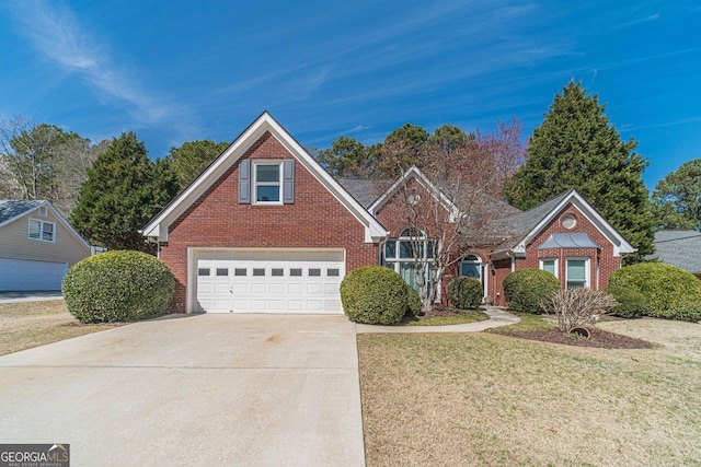 traditional home featuring brick siding, an attached garage, concrete driveway, and a front lawn