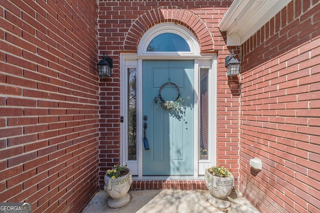 entrance to property with brick siding