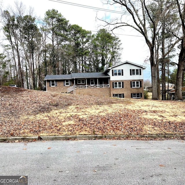 tri-level home featuring brick siding