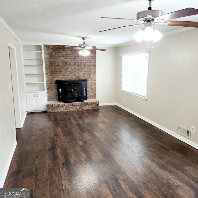 unfurnished living room with visible vents, built in shelves, baseboards, ornamental molding, and wood finished floors