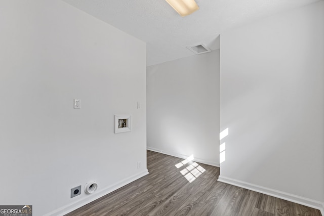 washroom featuring hookup for a washing machine, wood finished floors, visible vents, baseboards, and electric dryer hookup