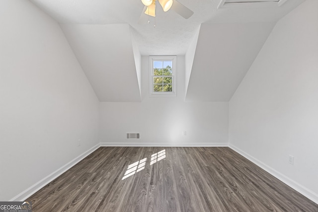 additional living space with baseboards, visible vents, and wood finished floors