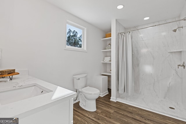 full bath with toilet, recessed lighting, a sink, wood finished floors, and a marble finish shower