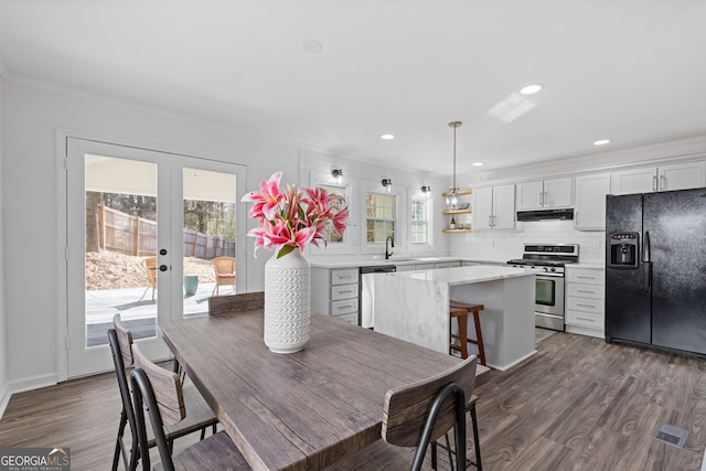 dining area featuring french doors, dark wood-style flooring, recessed lighting, and crown molding