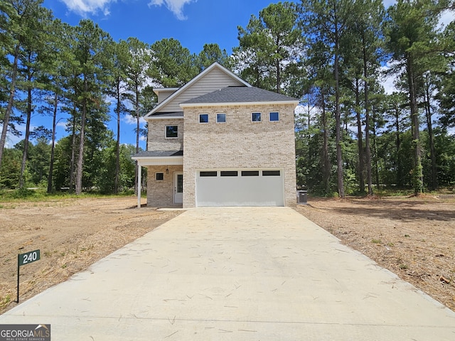 view of front of house featuring central AC, driveway, brick siding, and an attached garage