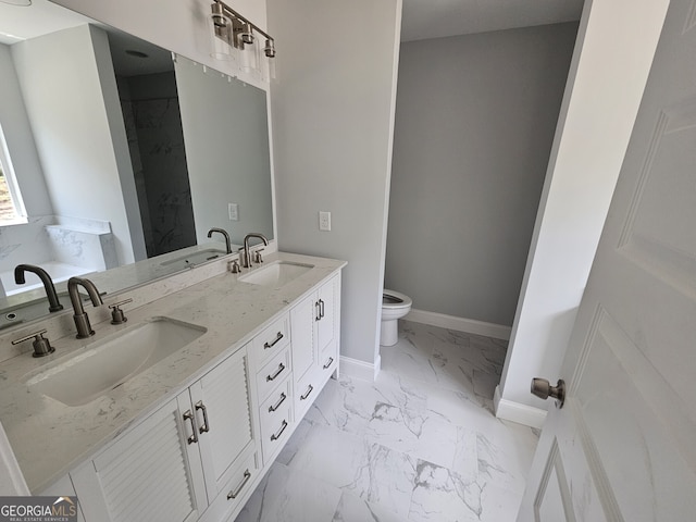 bathroom featuring marble finish floor, baseboards, and a sink