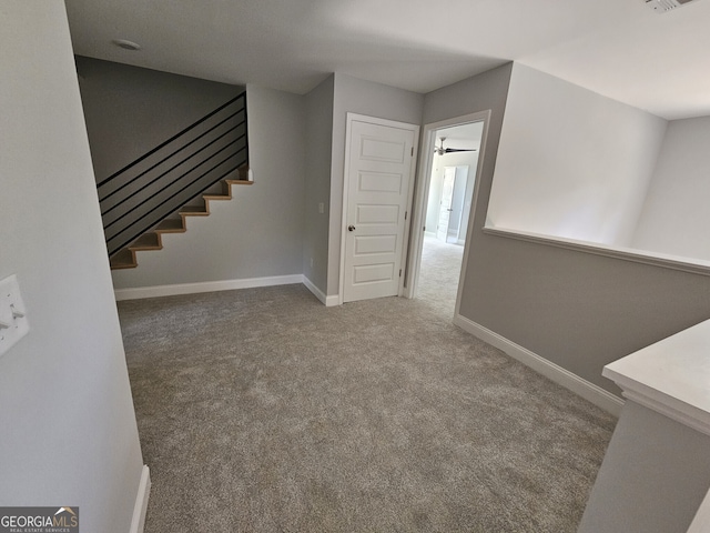 interior space featuring visible vents, baseboards, and carpet flooring