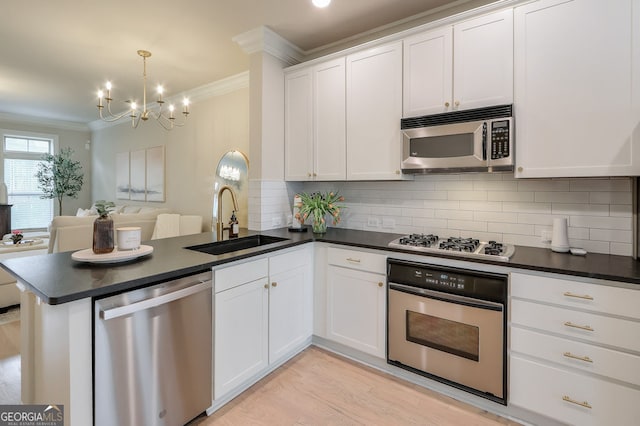 kitchen featuring a sink, crown molding, dark countertops, and stainless steel appliances