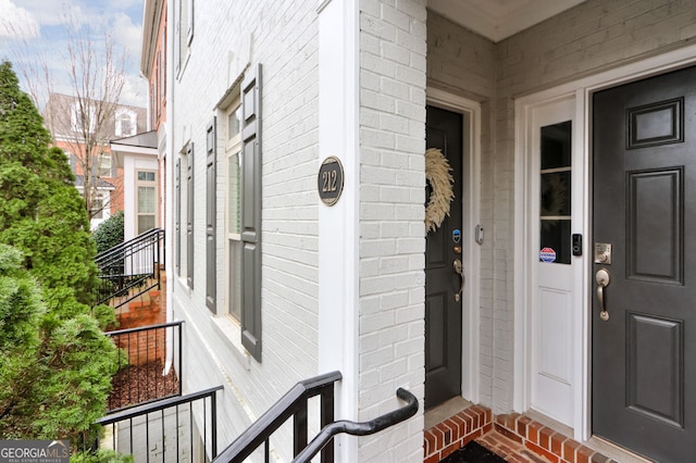 property entrance with brick siding