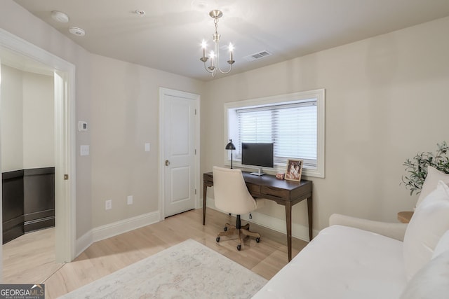 home office featuring visible vents, baseboards, wood finished floors, and a chandelier