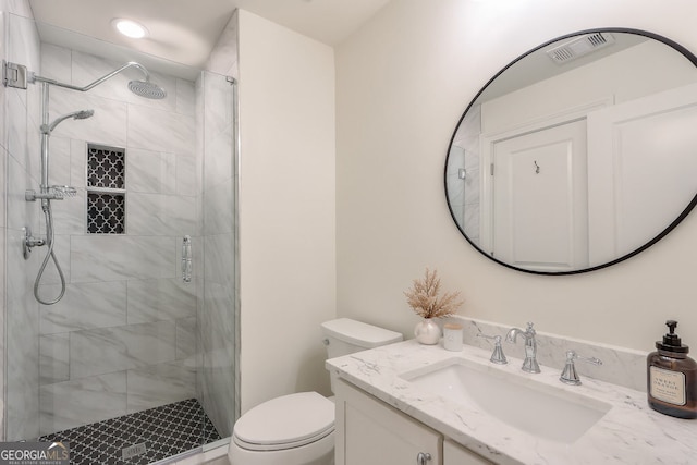 full bath featuring visible vents, a stall shower, toilet, and vanity