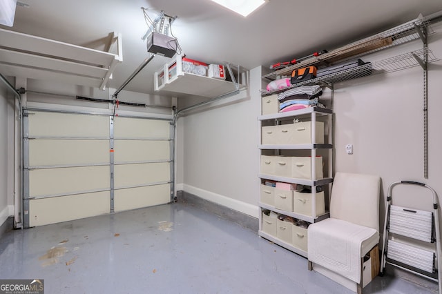 garage featuring a garage door opener and baseboards