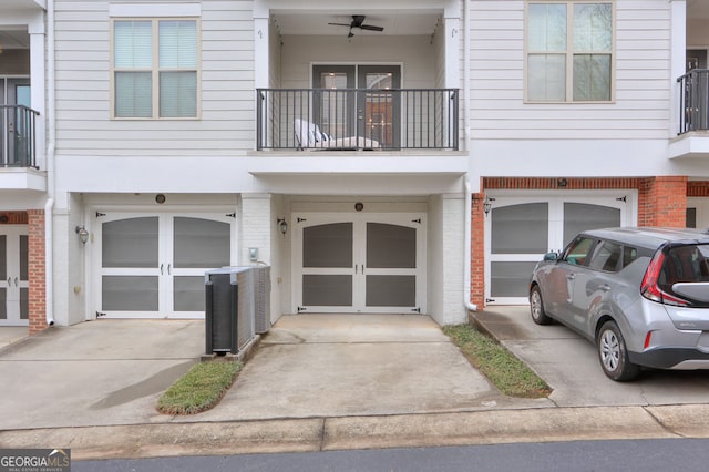 townhome / multi-family property with an attached garage, brick siding, and driveway