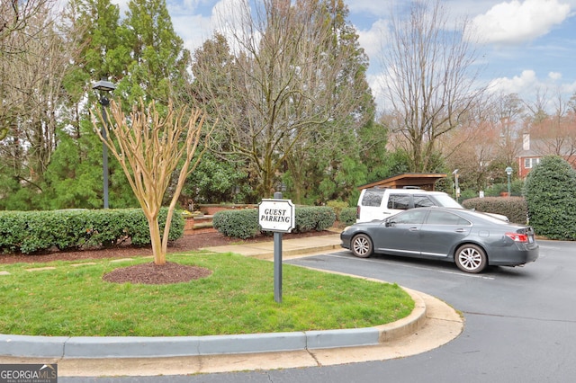 exterior space with a front yard and uncovered parking