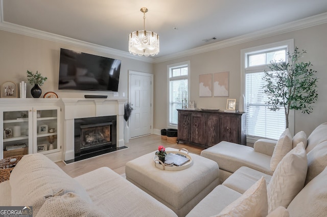 living room with plenty of natural light and ornamental molding