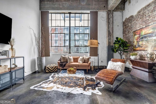 sitting room featuring concrete flooring