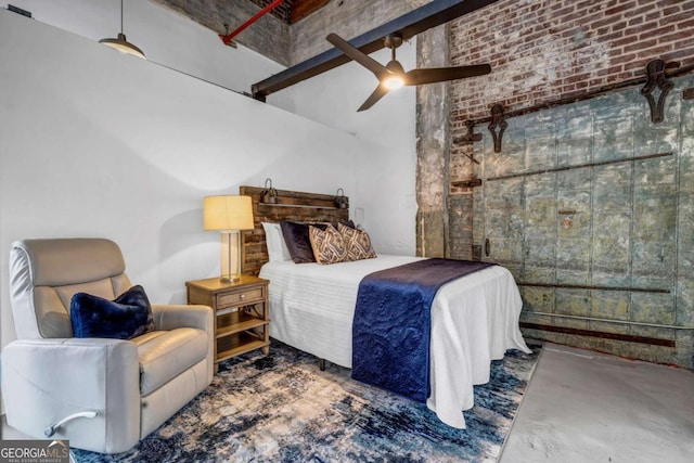 bedroom featuring brick wall, concrete floors, and ceiling fan