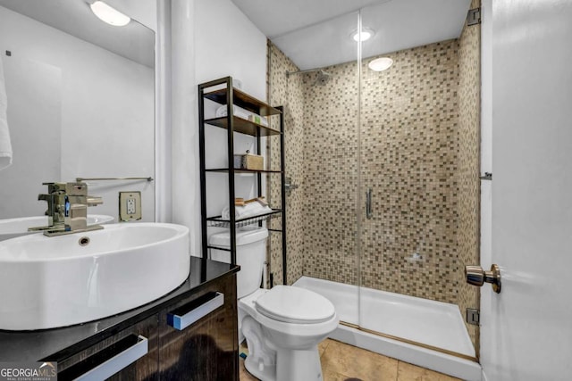 bathroom with vanity, a shower stall, and toilet