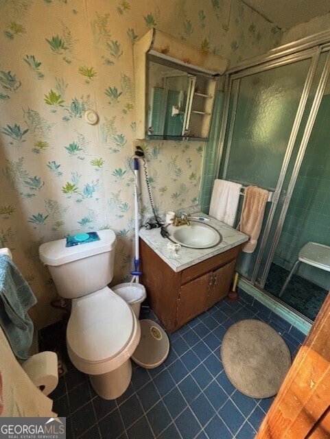 full bath featuring wallpapered walls, toilet, a stall shower, tile patterned floors, and vanity