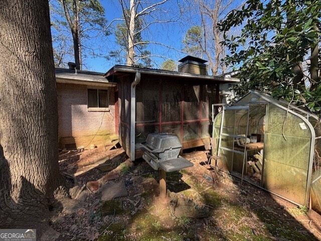 exterior space featuring an exterior structure, crawl space, an outbuilding, and brick siding