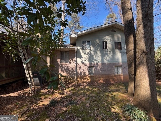 view of property exterior with brick siding