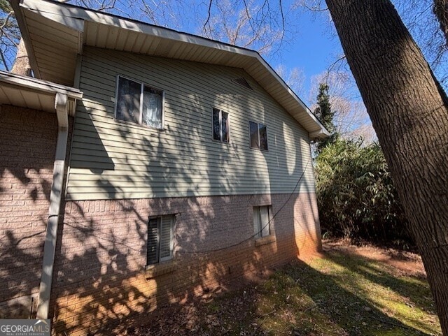 view of side of home featuring brick siding