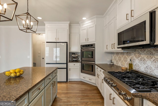 kitchen featuring dark wood-type flooring, white cabinets, backsplash, and stainless steel appliances