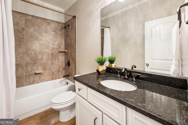 bathroom with vanity, wood finished floors, ornamental molding, shower / bath combo with shower curtain, and toilet